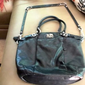 Well-worn black Coach leather handbag 16” X 13” with strap for cross-body.